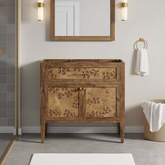 a bathroom with a sink, mirror and towel rack on the wall next to it