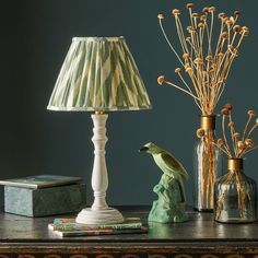 a lamp, vases and other items on a table