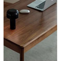 a laptop computer sitting on top of a wooden table next to a mouse and keyboard