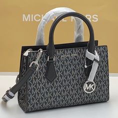 Michael Kors Sheila Small Faux Saffiano Leather Satchel Black/Silver ~Wt New With The Tag Authentic Day Or Night, The Sheila Satchel Is Always Chic And Ready To Go. This Faux Saffiano Leather Bag Is Designed In A Structured Silhouette With A Zip Closure For Added Security And A Slip Pocket Inside For Your Cardholder Or Phone. Carry It By The Elegant Top Handle, Or Attach The Included Shoulder Strap To Wear It Crossbody. Satchel Faux Leather 88.92% Coated Canvas/11.08% Polyester Silver-Tone Hardw Crossover Bags, Crossbody Satchel, Pink Crossbody Bag, Michael Kors Crossbody Bag, Travel Duffle, Cute Purses, Black Leather Bags, Mini Crossbody Bag, Purses Michael Kors