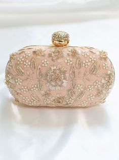 Peach Clutch for Women w/ Zardozi & Pearl embellishment & Gold chain strap Adorned with intricate floral Zardozi embroidery & pearl embellishments. This peach clutch purse with a stone-studded closure at the top is a must-have in your wardrobe - a versatile accessory for any party outfit!  Lining: Fabric Color: Peach Embroidery: Zardozi & Pearl Size & Dimensions:  Height - 5 in Width - 8 in Depth - 1.5 in Fits most of the phones. Strap: Detachable shoulder metal chain strap  Closure: Compartment Feminine Beige Evening Bag, Beige Feminine Evening Bag, Chic Pearl Embellished Evening Bag For Party, Elegant Hand Embellished Evening Bag For Events, Glamorous Embellished Evening Bag For Events, Chic Hand Embellished Party Bags, Glamorous Handheld Clutch With Pearl Handle, Feminine Clutch For Evening Events, Feminine Clutch Evening Bag For Events