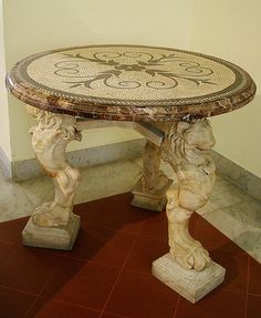 a marble table sitting on top of a wooden floor