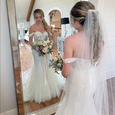 a bride looking at herself in the mirror