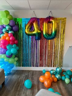 balloons and streamers are on the floor in front of a backdrop that says 40