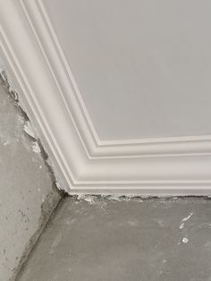 the corner of a room with white paint on it