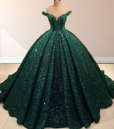 Radiate elegance and sparkle in this Dark Green Off-the-Shoulder Sequined Ball Gown Quinceanera Dress. This dress is crafted with shimmering sequin fabric that catches the light from every angle, making you the center of attention. It is available in rich dark green and vibrant red. The off-the-shoulder neckline highlights your decolletage with a graceful touch, while the sleeveless design adds timeless sophistication. A lace-up back adds a customizable fit, combining comfort with beauty. The cl Dark Green Wedding Dress, Dark Green Quinceanera Dresses, Green Quince Dress, Emerald Green Quinceanera Theme, Green Quinceanera Theme, Green Wedding Dress, Green Quinceanera Dresses, Green Ball Gown, Dark Green Wedding