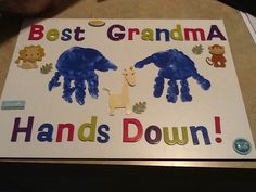 a sign that says best grandma hands down on the ground with pictures of handprints