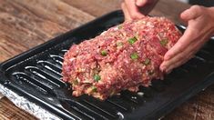 a person is placing ground meat on a grill