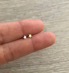 Teeny Tiny STAR Studs. They are super cute! * 1 pair * 14k Gold & Gold Filled * Star Size: 3.5 mm * Made in U.S.A. Gold Dainty Cartilage Earrings With Star Charm, Dainty Gold Cartilage Earrings With Star Charm, Gold Star-shaped Dainty Cartilage Earrings, Gold Dainty Star Cartilage Earrings, Dainty Gold Star Cartilage Earrings, Small Gold Cute Earrings, Tiny Star-shaped 14k Gold Jewelry, Gold Star Cartilage Earrings In Minimalist Style, Gold Star Cartilage Earrings Nickel Free