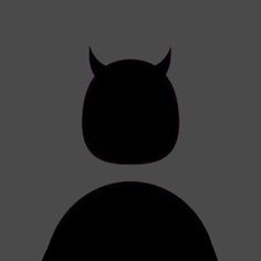 the silhouette of an animal with horns on it's head is shown against a gray background