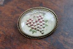 "Hauntingly beautiful antique Tuscan grape brooch {ca 1910} Similar to Essex crystal, these beautiful 'goofus glass' pins were made by carving an image into convex crystal and painting it from the back. This gives the image a three dimensional effect. The back is then coated in mother of pearl and set into a mount. Finished with an open c-catch on the reverse. Measures 1 1/2\" in diameter. Light wear, fitting for age." Vintage Intaglio Brooches Gift, Vintage Intaglio Brooches For Anniversary, Vintage Engraved Brooches For Gifts, Vintage Engraved Brooches As Gift, Reverse Painted Glass, Hauntingly Beautiful, Reverse Painted, Personalized Notes, Painted Glass