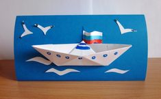 an origami boat with seagulls on it