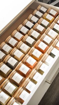 many bottles of wine are lined up on a shelf in front of the counter top