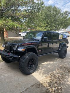 a black jeep parked on the side of a road