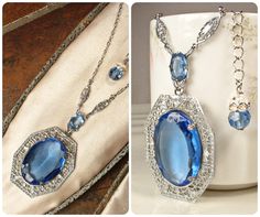 Offering an absolutely stunning vintage 1920s to 1930s era Art Deco sapphire blue bezel set faceted glass crystal and silver rhodium plated filigree pendant necklace.  This is the perfect "Something Old" and "Something Blue" for the bride!   The 1 5/8 inch (41 cm) by 1 1/4 inches at 1 5/16 inches (3.3 cm) ornate embossed filigree pendant features a central oval cut bezel set faceted glass crystal in the most beautiful shade of sapphire blue.  It hangs from a smaller open back faceted glass crystal also in blue.  This in turn is suspended from rhodium plated filigree links on either side.  The rest of the necklace is a platinum tone replacement chain with that fastens with a ring clasp.  It has an extender chain for versatility and can be worn from about and measures 21 3/8 to 23 7/8 inches Heirloom Blue Necklaces For Weddings, Art Deco Crystal Jewelry For Vintage Events, Art Deco Crystal Jewelry For Vintage, Art Deco Sapphire Jewelry With 17 Jewels, Sapphire Art Deco Jewelry With 17 Jewels, Vintage Sapphire Jewelry For Formal Occasions, Vintage Sapphire Necklaces For Anniversary, Vintage Oval Sapphire Jewelry, Vintage Sapphire Necklace For Anniversary