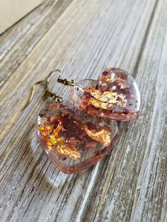 Beautiful natural rose petals in heart resin earrings. Hues of amber red paired with fiery copper flakes make these natural earrings boldly colorful. Bronze metal earrings with handmade resin heart pendants with real dried rose petals ♥ Be sure to check out the ORANGE EARRINGS section at EarringsbyLCreations for all beautiful orange colored earrings available! https://www.etsy.com/shop/EarringsByLCreations?section_id=28420987 Made with quality materials and always nickel and lead free metals. Na Resin Heart Earrings For Gifts, Valentine's Day Heart-shaped Flower Earrings For Pierced Ears, Pink Heart-shaped Flower Earrings For Gift, Pink Heart-shaped Flower Earrings As Gift, Gold Heart-shaped Flower Earrings, Heart-shaped Gold Flower Earrings For Valentine's Day, Gold Heart-shaped Flower Earrings For Valentine's Day, Rose Gold Heart Drop Earrings For Gift, Rose Gold Dangle Heart Earrings Gift