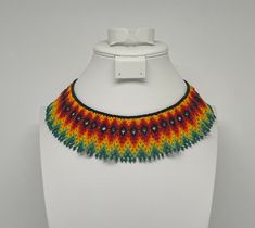 This beautiful beaded necklace is hand-woven by the women of the Embera Chami Indigenous Tribe of Colombia Artisan Beaded Adjustable Bib Necklace, Artisan Beaded Bib Necklace With Adjustable Fit, Traditional Adjustable Bib Necklace With Round Beads, Traditional Bib Necklace With Adjustable Round Beads, Traditional Bib Necklace With Round Beads, Handmade Adjustable Bib Necklace With Round Beads, Fair Trade Beaded Necklaces As Gift, Adjustable Artisan Bib Necklace With Round Beads, Artisan Handwoven Choker With Round Beads