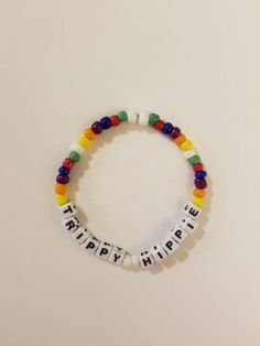 Layer and stack with this super cute rainbow trippy hippie bracelet. Made from high quality durable elastic string and beautiful seed beads that will sit comfortably on your wrist. Secured with a stopper bead and a knot. . CARE: It is best to wear this bracelet by rolling it on and off the wrist to avoid stretching and breakage. These bracelets are not designed to be over stretched and excessive force and pulling can result in breakage. This bracelet is about 6.5 inches. (But made with a little Bohemian Rainbow Letter Beads Friendship Bracelet, Hippie Style Colorful Beaded Bracelets As Gift, Playful Adjustable Multicolor Friendship Bracelets, Hippie Hand-strung Friendship Bracelets With Round Beads, Hand-strung Hippie Friendship Bracelet With Round Beads, Bohemian Rainbow Bracelets With Letter Beads, Adjustable Rainbow Friendship Bracelets With Letter Beads, Colorful Adjustable Casual Beads, Adjustable Multicolor Hypoallergenic Stretch Bracelet