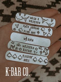 four metal tags that say wild and western