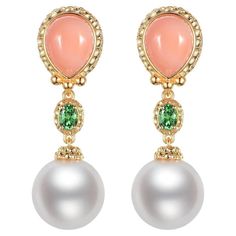 Emanate elegance with these exquisite drop earrings, featuring the natural beauty of South Sea pearls. Crafted with a lustrous 18K gold vermeil over sterling silver, each earring showcases a smooth, pink coral, weighing a total of 4.65 carats, set in a delicately detailed halo that reflects a vintage charm. Above the coral, a vibrant green tsavorite glints, its 0.48-carat weight adding a touch of color contrast, while the luxurious South Sea pearls dangle gracefully below, completing the earrings' opulent design. These earrings are a perfect marriage of the ocean’s treasures, combining color, texture, and luster in an extraordinary display of craftsmanship. Ideal for special occasions or to elevate your everyday style, these earrings are a testament to classic beauty with an enchanting twi Coral Drop Earrings, Perfect Marriage, South Seas, South Sea Pearls, Sea Pearls, Pink Coral, Vibrant Green, Color Contrast, Classic Beauty