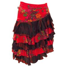 This ultra feminine red floral satiny soft skirt comes from vintage Jean Paul Gaultier. A fitted waist with side zip falls to tiered layers of sheer black mixed with red florals.