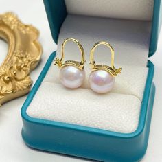 Discover the essence of modern elegance with our Freshwater Pearl Bucket-Shaped Earrings. Each piece features a captivating 11-12mm round freshwater pearl of AAA quality, exuding classic sophistication. Meticulously crafted in 925 sterling silver, with an option for 18k gold vermeil, these earrings showcase a sleek, contemporary design. The distinctive bucket shape combines a minimalist approach with the timeless allure of pearls, creating a versatile accessory ideal for any ensemble. A perfect Double Strand Pearl Necklace, Large Pearl Earrings, Popular Necklaces, Pearl Strands Necklace, Golden South Sea Pearls, Purple Pearl, Freshwater Pearls Earrings, Pearl Set, Freshwater Pearl Necklaces