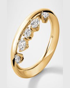 a gold ring with five diamonds on it