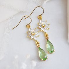 "Flower Earring // Light Green Earrings // Bridesmaids Earrings // Boho Bridal Earrings // Whimsical Earrings // Floral Drop Earrings // 14k Gold Filled Earrings These beautiful whimsical earrings are created with a unique cubic zirconia floral design. Secured to them are light green faceted glass teardrops. The flower earrings are secured to dainty 14k gold filled earring wires for a comfortable all day wear. Whether searching for green jewelry for your bridesmaids or unique floral earrings for your wedding day, all of my jewelry arrives suitably gift wrapped ready for gift giving. Measurements: The length of the dainty flower earrings hang a little over 1.5\" long Metals: 14k gold filled earring hooks 14k gold filled jump rings Gold plated cubic zirconia Gold plated teardrops Complete th Enchanted Forest Earrings, Sage Green Wedding Jewelry, Sage Green Jewelry, Light Green Jewelry, Sage Green Earrings, Spring Wedding Jewelry, Green Wedding Jewelry, Light Green Earrings, Green Flower Earrings