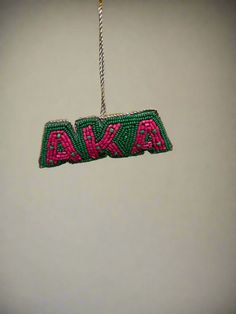 a beaded name ornament hanging from a string