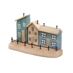 a small wooden house with two blue houses on it