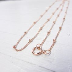 This listing is for (1) Rose Gold Filled Finished Chain Shiny finish 18in 1mm Saturn Curb Chain Spring Ring 1.8mm Beads Length between beads 1/2in. Ideas for this piece: Design Ideas Add a charm for a delicate charm necklace Link in rondelles with 26 gauge wire for extra interest Layer with existing necklace designs Beaded Ball, 1 Rose, Bee Charms, Curb Chain, Gold Filled Chain, Ball Chain, Sterling Silver Bead, Beaded Chain, Necklace Designs