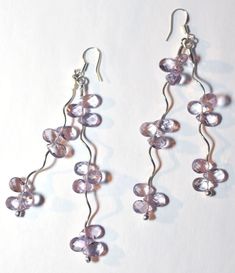 Whether night or day, these delicate Amethyst earrings will be sure to dangle the sorrow away.  The light just dances on these stones and you are sure to turn heads when wearing them.    Stones - Amethyst Finding\/components - Sterling silver  STONE COLOR - Pictures were lighted to show detail. See last picture for actual stone color.  NOTE: Slight variations in the piece you will receive from the one pictured are to be expected due to the hand made nature of the item.   Photos by Evan Spring  A Amethyst Powers, Rocks Collection, Earrings Nature, Color Pictures, Rock Collection, Amethyst Earrings, Just Dance, Wire Earrings, Colorful Pictures