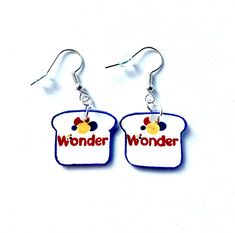 "These earrings were inspired by the love of Wonder Bread. Andy Warhol made a soup can into art. Why not turn a Wonder Bread bag into art? Everyone remembers eating the favorite bread as a child and as an adult. Who doesn't recognize the iconic logo? Wonder Bread is still the coolest thing since sliced bread.Perfect Gift for the Wonder Bread lover, an art teacher, foodie and anyone that likes to wear something fun. This product is affiliated with Wonder Brands Inc., a Canadian Corporation. They come with plastic earring backs so you won't lose them. Free shipping to Canada and only a $5.00  handling fee. Don't sit and \"wonder\" if you want these earrings, order them while you can. Each one is individually hand colored and cut out so they might vary slightly from the example shown, but you Wonder Bread, Earrings Food, Bread Bag, Sliced Bread, Bread Bags, Food Earrings, Plastic Earrings, Art Earrings, Into Art