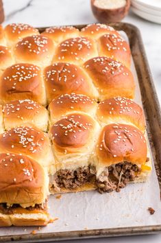 a meatball slider cut in half on a baking sheet