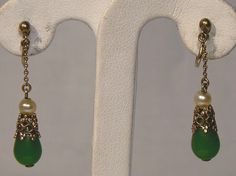 DO NOT PURCHASE. Missing from inventory.  An Art Deco gilt 830 silver filigree pair of 1-3/8" screw-back dangle earrings circa 1920s.  These vintage Danish 1 1/4" length earrings feature glass pearls, silver openwork and jade green glass drops.  They are stamped 830S and CA. We believe these earrings were designed by C.F. Andreasen (Copenhagen 1893 - 1937). Our thanks to the www.925-1000 site for the reference information.  They weigh 2.0 grams, and they are in excellent condition with no chips, cracks, dents, bends, corrosion, losses, damage or repairs. Jewelry is vintage and has signs of use and patination as would be expected. Expedited parcel to the U.S. starts at $20.00 and expedited parcel within Canada starts at $15.00 (tracking and loss insurance included). Rates vary by destinatio Vintage Drop Earrings With Matching Set, Vintage Drop Jewelry Set With Matching Earrings, Vintage Drop Earrings For Pierced Ears, Vintage Drop Jewelry For Formal Occasions, Vintage Formal Drop Earrings, Formal Vintage Drop Earrings, Ornate Dangle Clip-on Earrings For Formal Occasions, Green Filigree Earrings For Formal Occasions, Green Formal Filigree Earrings