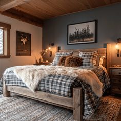 a bedroom with a bed, dressers and pictures on the wall above it is decorated in rustic style