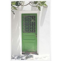 a green door is in front of a white wall