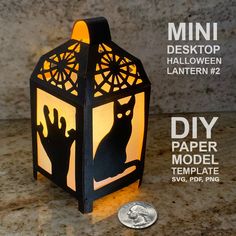 a paper lantern that is shaped like a cat and has the silhouette of two cats on it