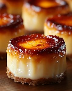 small desserts with jelly on them sitting on a wooden table top, ready to be eaten