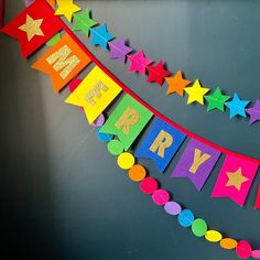 a happy birthday banner with stars and confetti hanging from it's sides