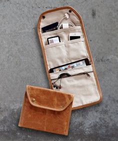 an open case with electronics inside it on a white background and a brown leather pouch