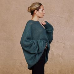 The versatile, luxurious, and elegant silhouette of the sweater ASTRID can be a part of many different looks, at the same time keeping you warm and cosy.  Hand-crafted from premium alpaca and mohair blend, this fluffy pullover features an oversized fit, raglan shoulder construction and extra-long sleeves. Style with jeans for a more casual look, or elegant trousers/skirt for an evening. DETAILS -Oversized -Boat neck -Extra-long puffed sleeve -Raglan shoulder construction Designed and ethically m Luxury Hand-knitted Long Sleeve Sweater, Luxury Oversized Knit Top, Luxury Fitted Alpaca Sweater, Luxury Green Knit Sweater, Luxury Alpaca Elegant Sweater, Luxury Oversized Alpaca Sweater, Luxury Oversized Chunky Knit Tops, Luxury Elegant Alpaca Sweater, Luxury Long Sleeve Mohair Tops