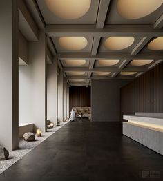 an empty room with several lights on the ceiling and some rocks in the floor next to it