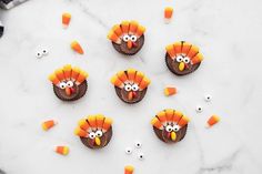 cupcakes decorated to look like turkeys with candy candies on the side