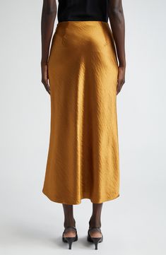 Hammered texture elevates the elegant look of this bias-cut satin skirt in a burnished golden hue that evokes autumnal splendor. 36 1/2" length (size 8) Hidden side-zip closure 100% polyester Dry clean Imported Designer Clothing Gold Silk Bottoms For Party, Elegant Gold Lined Skirt, Elegant Gold Silk Bottoms, Gold Long Skirt For Formal Occasions, Elegant Lined Gold Skirt, Gold Satin Party Skirt, Gold Formal Bottoms, Gold Long Skirt For Evening, Elegant Gold Mini Skirt