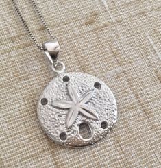 ".925 Sterling Silver Hawaiian Beach Ocean Sand Dollar Necklace. The size is 20MM, about 3/4\". FREE Italian Sterling Silver Diamond cut box Chain Included In your choice of length. --Part of our popular Sand Dollar collection in our Maui stores. The Highly-reflective Sterling Silver finish provides the expensive look of Fine Jewelry. This may also be worn on your White Gold chains. The finish is also very durable and maintains its stunning appearance over a long period of time. --Packaged ready Silver Engraved Necklace For Beach, Silver Round Beach Necklace, Silver Necklace For Beach, Nickel Free Silver Jewelry For Vacation, Nickel-free Silver Jewelry For Vacation, Tropical Necklace, Whale Tail Necklace, Hawaiian Necklace, Sand Dollar Necklace