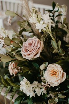 a vase filled with lots of flowers on top of a table