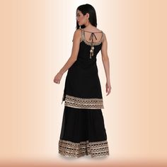 Introducing our new Elegant Garara Set with Gold Accent - Black! This garara set is perfect for any special occasion, whether you're attending a wedding or just want to dress up for a night out. The heavy gold gota accents on the edge of the top, garara, and dupatta add a touch of luxury, while the simple design keeps it elegant and timeless. We know you'll love this garara set as much as we do! Fabric for sleeves is included in all of our clothing, unless specified otherwise. Ready To Wear Saree, Sari Blouse, Gold Accent, On The Edge, Saree Blouse, Exclusive Collection, The Edge, Gold Accents, Simple Design