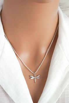 This simple and elegant dragonfly necklace is made of 925 sterling silver with a clear cubic zirconia rhinestone on the wing. It makes a lovely everyday necklace for those who love dragonflies. This necklace includes: - Dragonfly pendant: (18 x 18 mm | approx 3/4 in x 3/4 inch, including the bail) - anchor, snake, rope or curb link chain (16 to 30 inches) ADD INITIAL CHARMS: https://etsy.me/3gMPv4r ADD BIRTHSTONE CHARMS: https://etsy.me/3gGTLT4 ADD BIRTHSTONE BEAD CHARMS: https://etsy.me/3gGltzv Elegant Silver Dragonfly Jewelry, Elegant Sterling Silver Dragonfly Jewelry, Dainty Silver Dragonfly Jewelry, Dainty Sterling Silver Dragonfly Jewelry, Elegant Sterling Silver Dragonfly Necklace, Silver Dragonfly Jewelry, Dragonfly Jewelry Necklace, Sterling Silver Dragonfly Necklace, Dragonfly Gifts