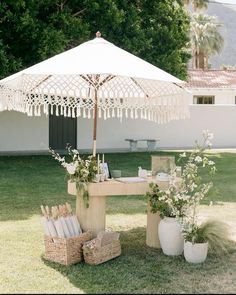 a table with an umbrella and baskets on it